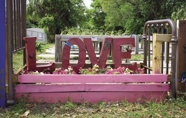 the word Love sculptured in a flower bed