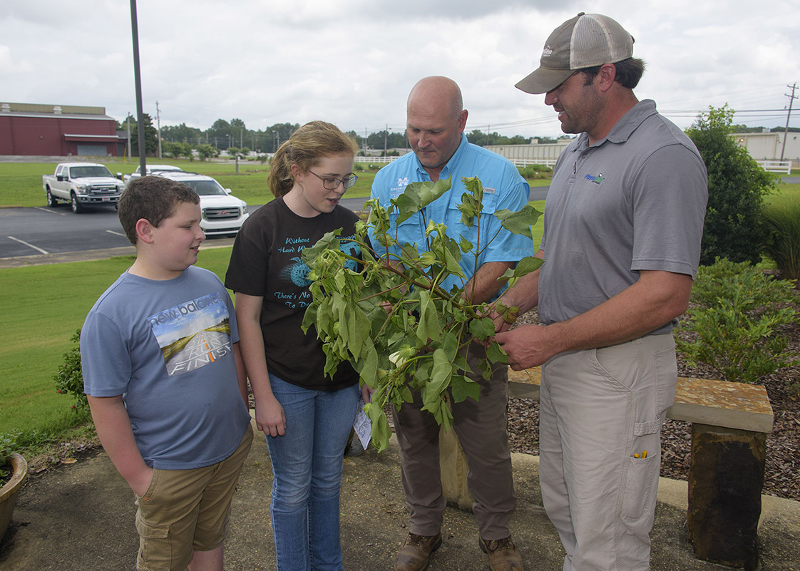 Two adults and two agronomy camp attendees.