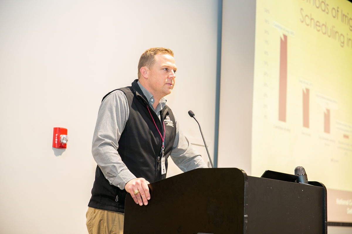 A man stands behind a podium. 