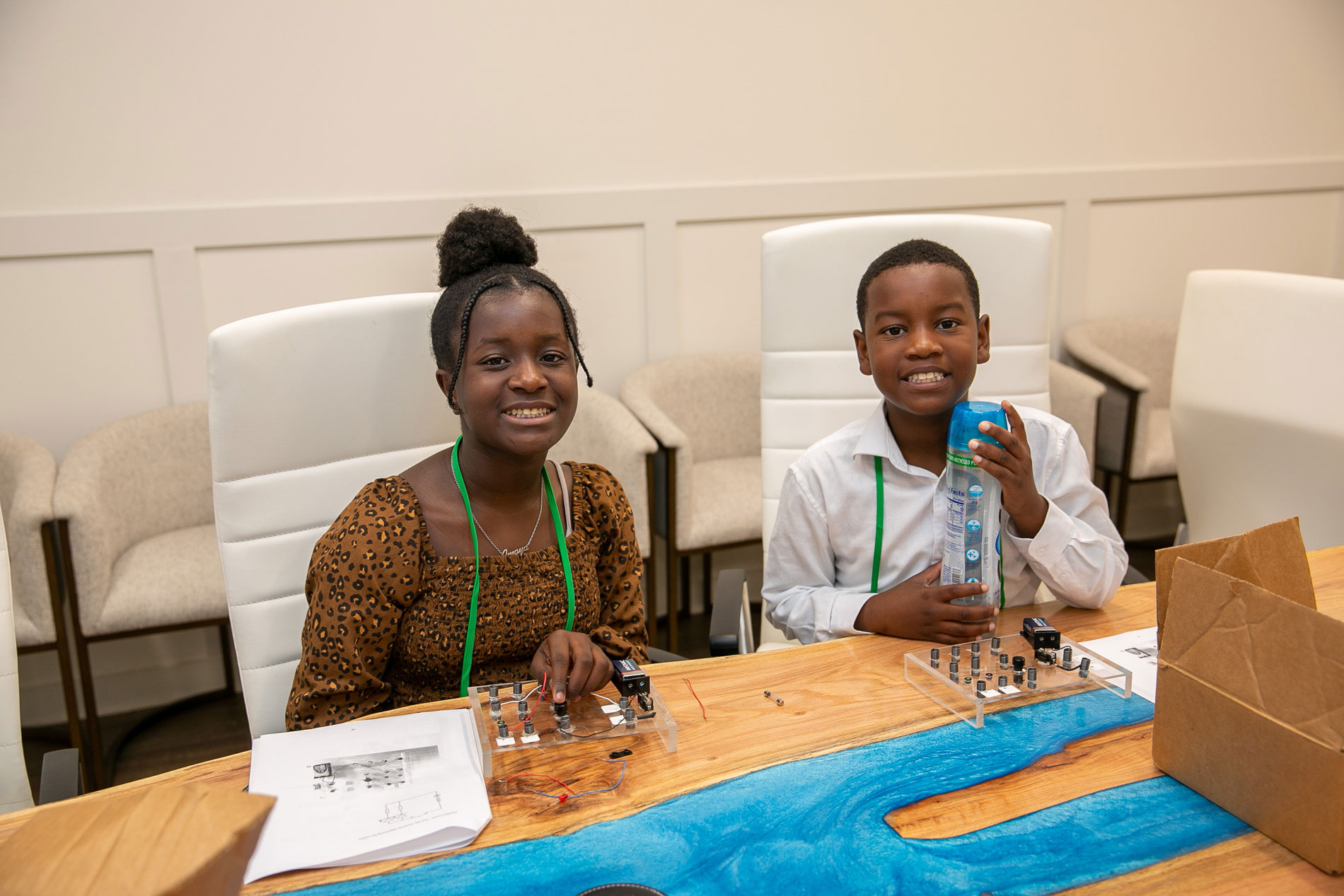 A girl and boy working with batteries.