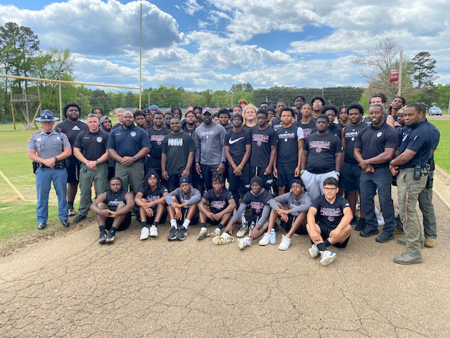 A group of people, including young men and police officers.