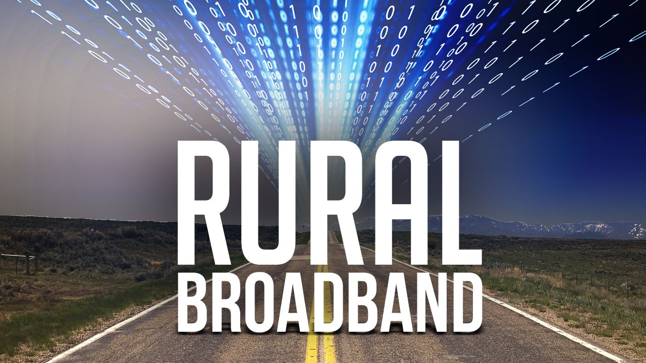 Photo illustration with two-lane highway with computer code and the words "Rural Broadband" superimposed.