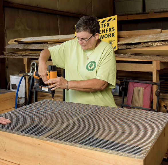 A person uses a drill to make a salad table.