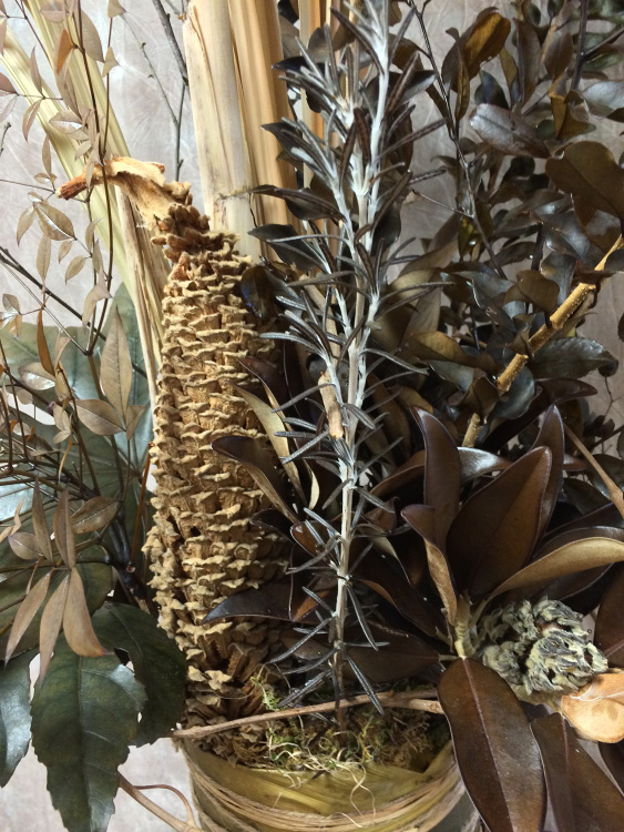 Arrangement of a variety of dried floral materials.