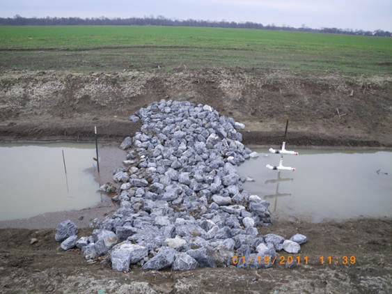 A large strip of rocks separating two pools of water.