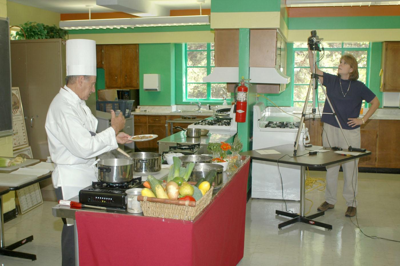 Mississippi State University Extension Service distance education coordinator Susan Seal runs the video camera while MSU chef Roland Parny demonstrates cooking techniques during a recent Quick Bites program. (Photo by Bob Ratliff)