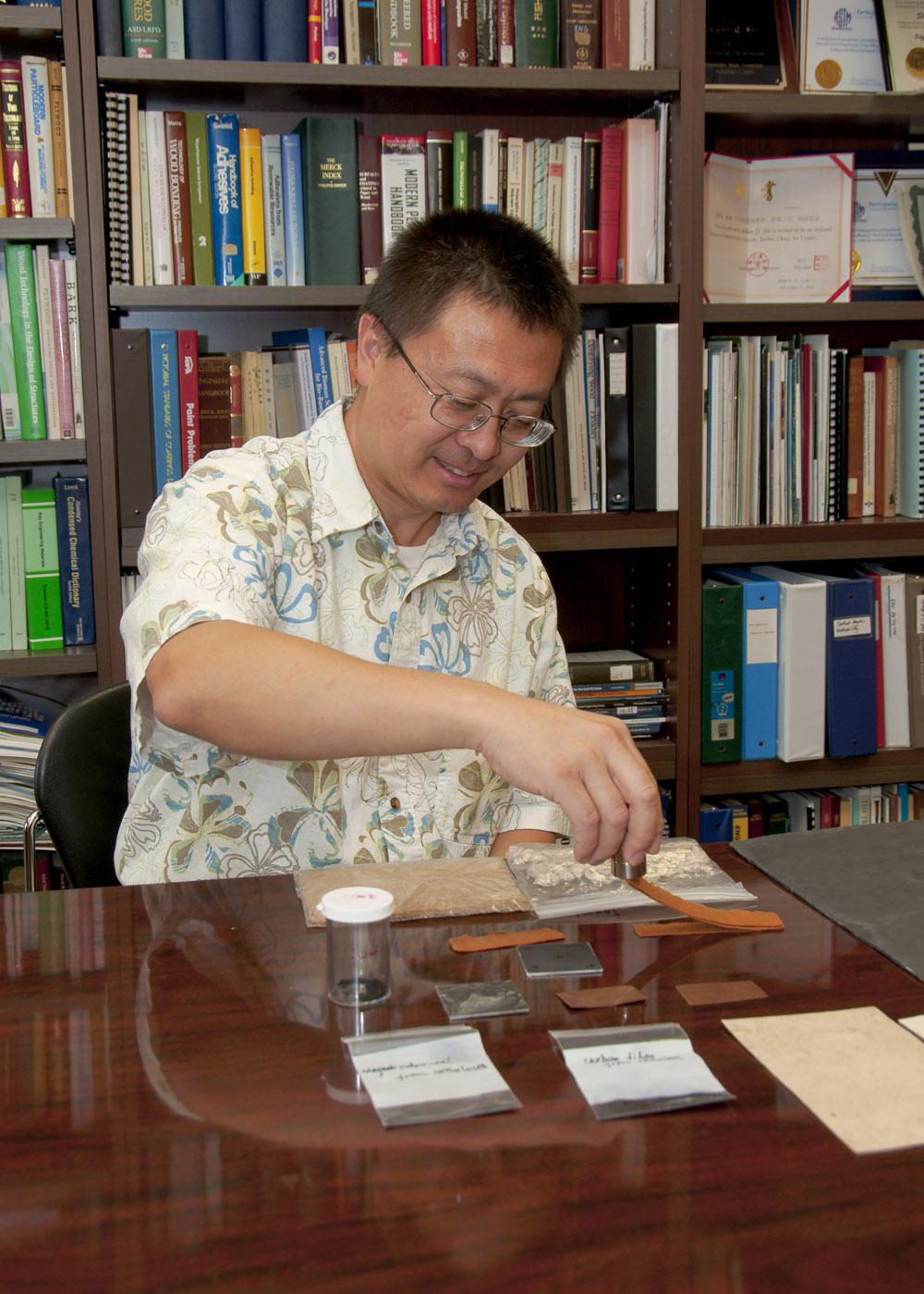 Mississippi State University forest products assistant professor Sheldon Shi demonstrates the effectiveness of magnetic charcoal. Shi and his colleague Dongmao Zhang found a new way to create charcoal and other carbon-based products with a higher absorption capacity.