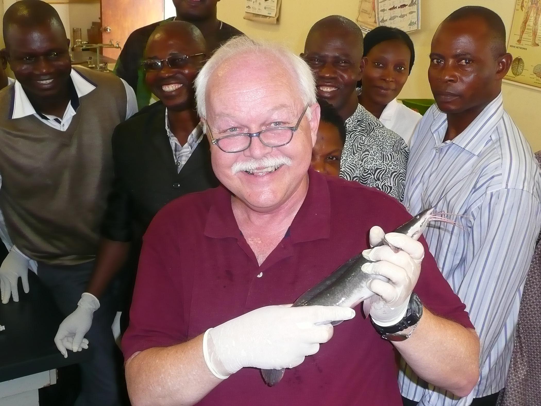 Dr. Skip Jack, Mississippi State University veterinarian, spent three weeks in Nigeria teaching about fish health. Here, he holds a Clarius catfish with some students in Lagos, Nigeria. (Submitted Photo)