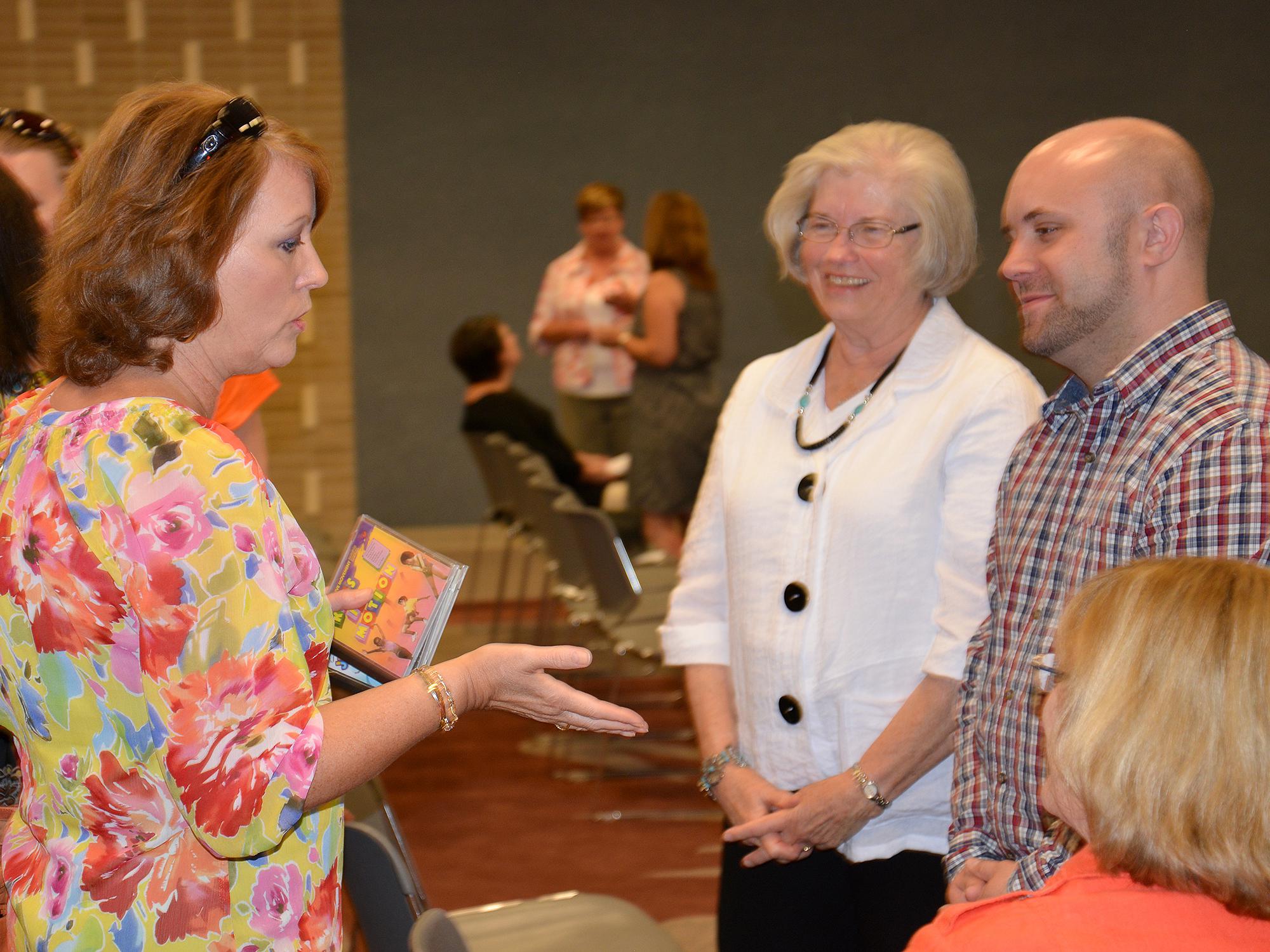 Bridget Fulton, left, a child care provider from Meridian, talks with Karen Ponder and Chad Allgood, Mississippi State University Early Years Network consultants. The Early Years Network went on the road in October to discuss changes in the program made to better serve child care providers across the state. (Photo by MSU School of Human Sciences/Amy Barefield)