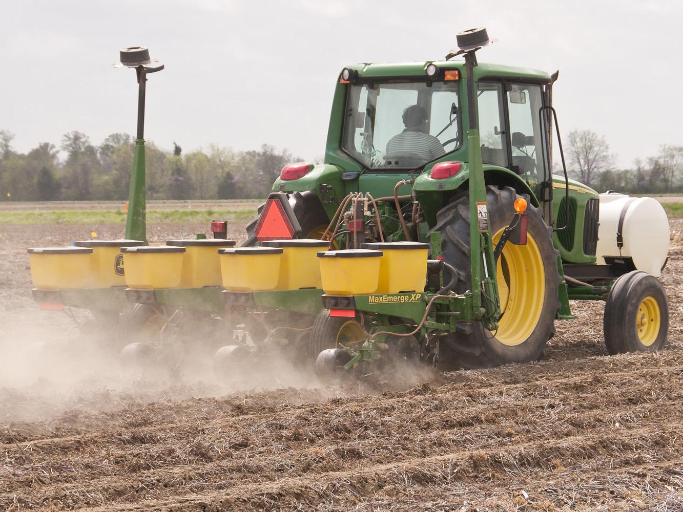 A Mississippi State University worker at the Northeast Mississippi Branch Experiment Station in Verona takes advantage of the ideal weather for corn planting on April 7. (Photo by Scott Corey)