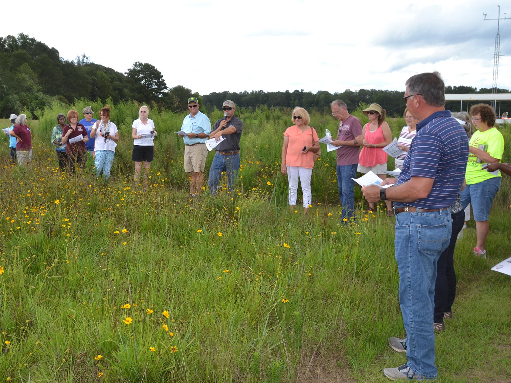 Brett Rushing, an assistant professor at Mississippi State University, discusses various planting and maintenance methods used on four native wildflower plots at the MSU Coastal Plains Branch Experiment Station in Newton on July 13, 2017, during the Wildflower Field Day. (Photo by MSU Extension Service/Susan Collins-Smith)