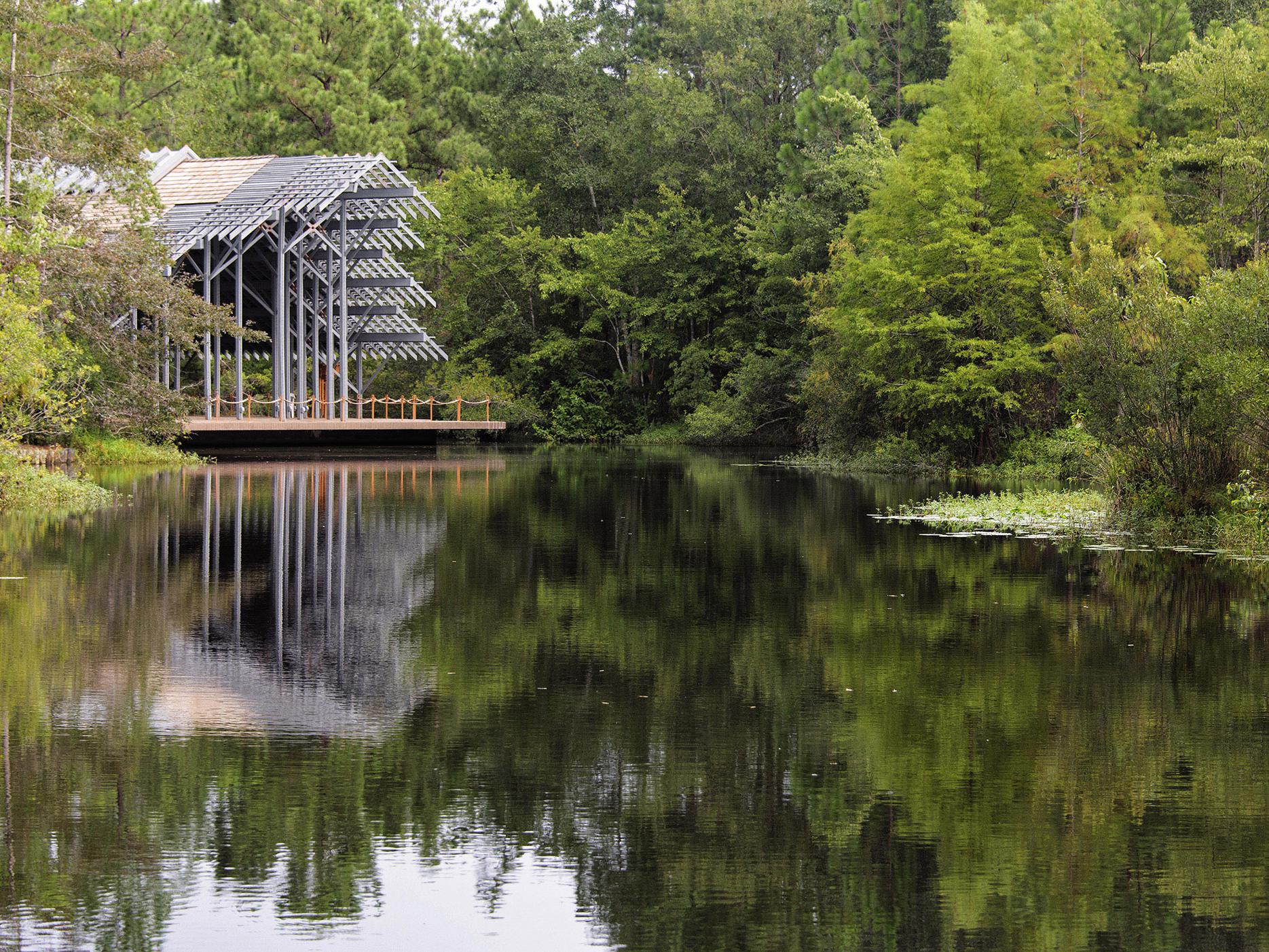 The Pinecote Pavillion stands in the background of the pond at the Crosby Arboretum.