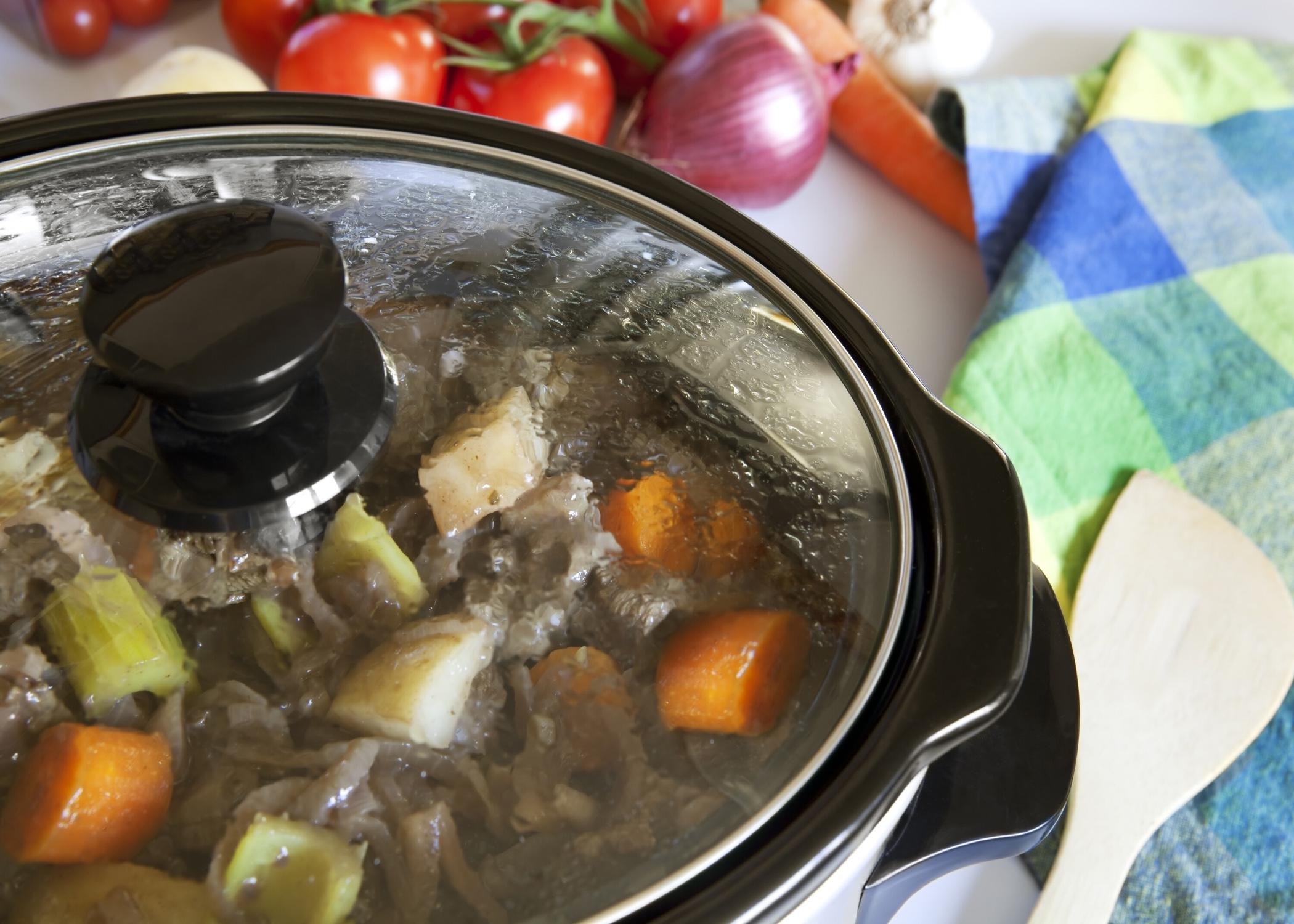 A slow cooker filled with food.