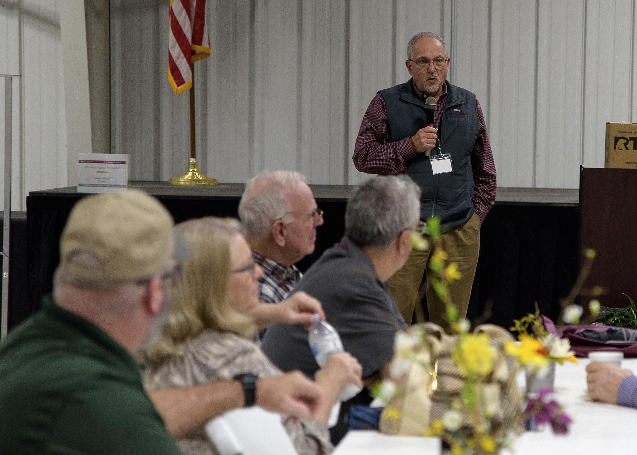 A group of people listen to a public speaker.