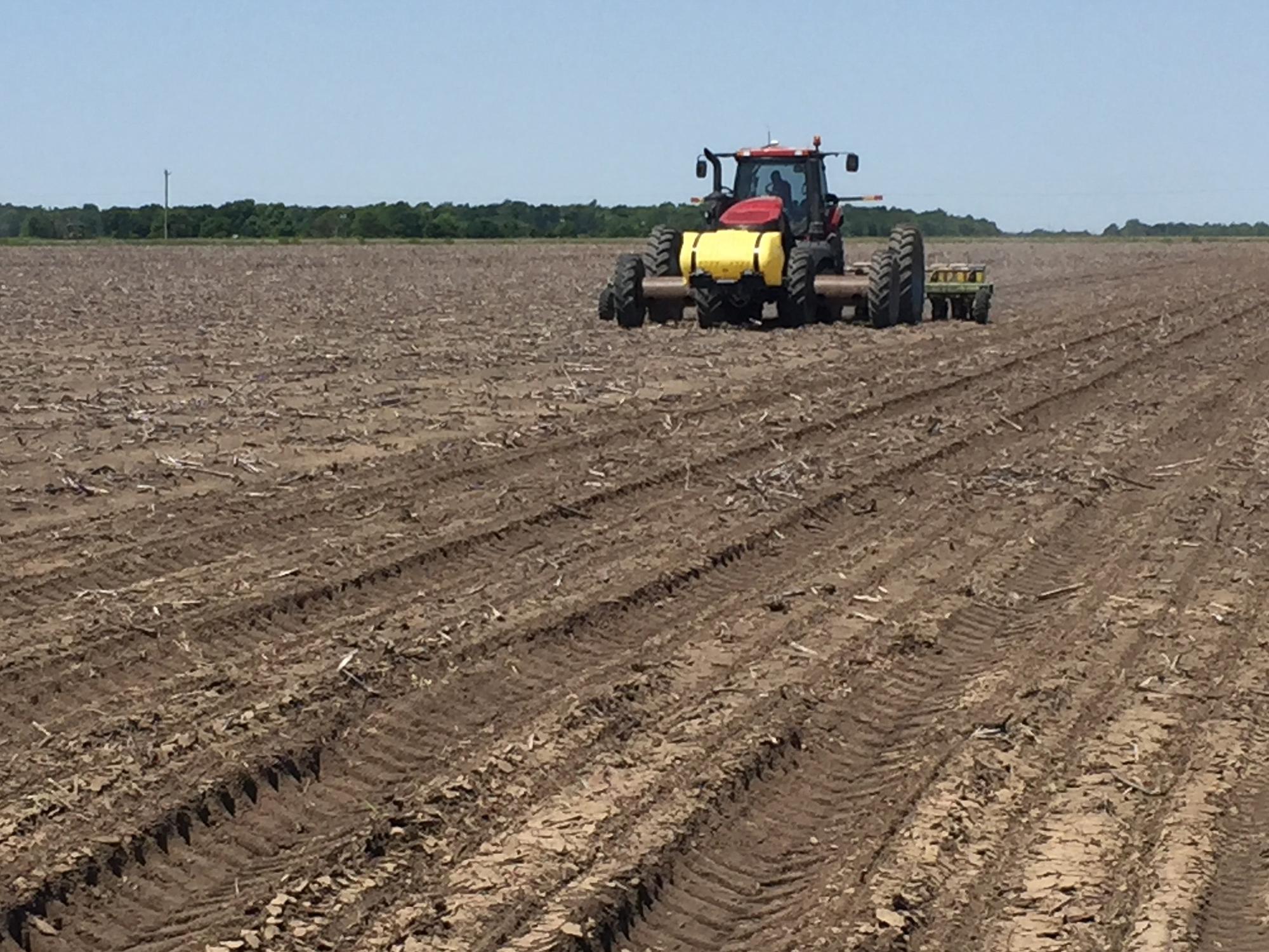 Clear skies have been rare sights as Mississippi farmers started planting their 2016 crops. This soybean planter is establishing a variety trial in a Sunflower County field on May 10, 2016. (MSU Extension Service photo/Greg Flint)