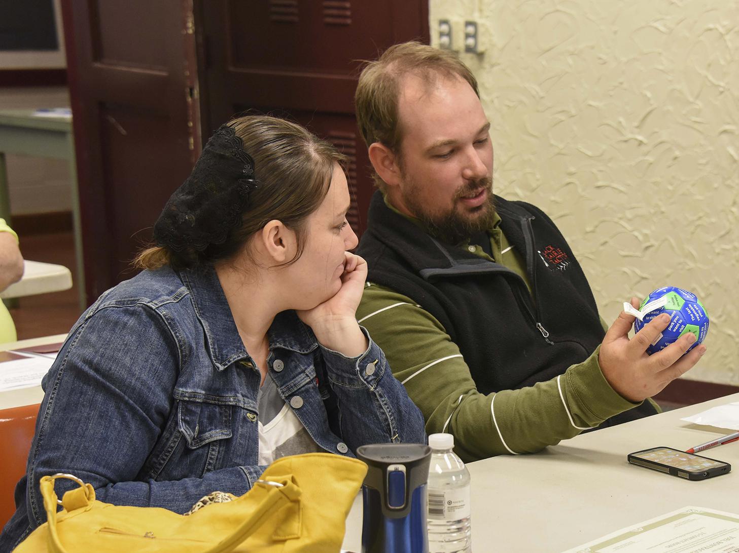 Althea and Joel Bontrager of Columbus examine a communication ball at the beginning of a three-hour workshop for foster/adoptive parents in the Oktibbeha County Extension Office on March 19, 2016. (Photo by MSU Extension Service/Kevin Hudson)