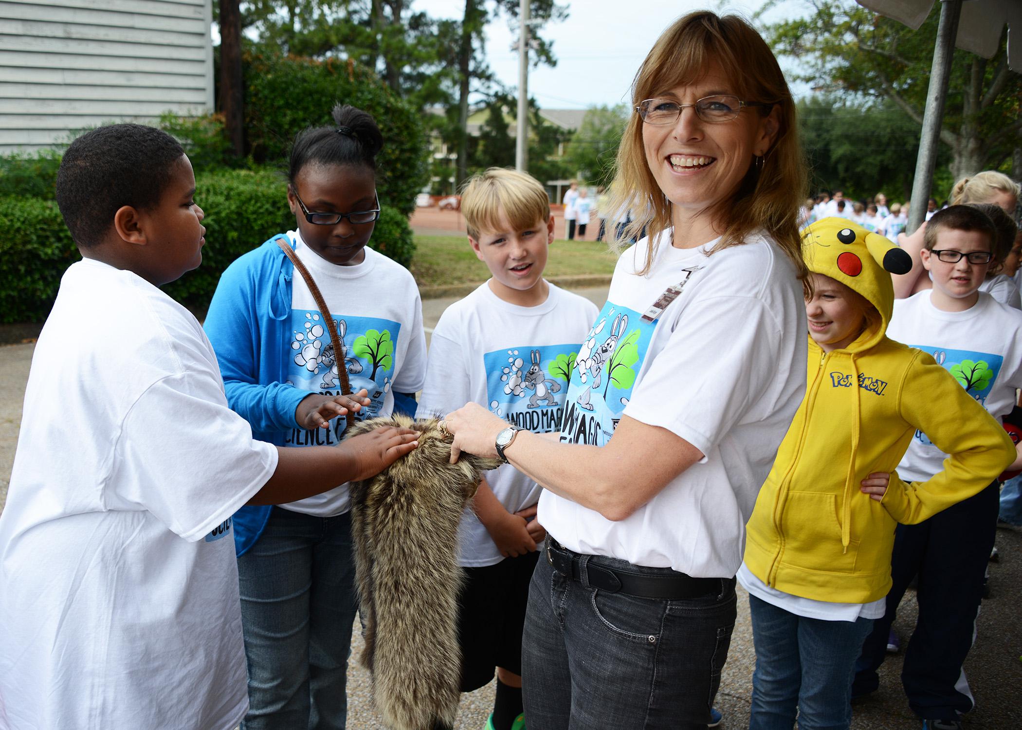 Leslie Burger, an instructor with the Mississippi State University Extension Service, teaches children about animals that inhabit Mississippi forests. (Photo by MSU College of Forest Resources/David Ammon)