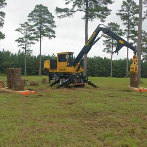 A loader grabbing a log.