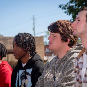 Four boys listening intently.