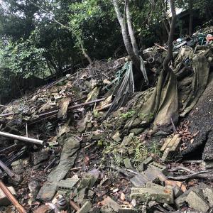 Ground covered in trash, cloth, and bricks.