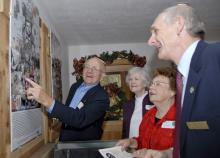 Longtime 4-H advocates, from left, Don Taylor, Zona Dale Taylor, Dot Taylor and Charles Taylor admire a poster displaying historical events of the 1960s. The posters are part of an exhibit at the Mississippi 4-H Learning Center and Pete Frierson 4-H Museum in Jackson. (Photo by Tom Thompson)