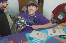 Robotics competitor Keelan Ready, of Hernando, checks programming adjustments on her team's robot. (Photo by Patti Drapala)