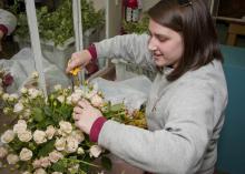 Mississippi State University senior Meryl Williams of Columbus selects flowers and foliage for a corsage project in her wedding floral design class. (Photo by Scott Corey)