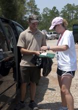 Vivian Cade with Mississippi State University Extension Service signs the paperwork to receive a bird to transport to the Wildlife Rehabilitation Center in Gulfport. (Photo MSU Extension/Alicia Barnes)