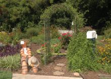 The entrance to the Hill Garden is highlighted by a figure made from flower pots, a covered archway and a mailbox. (Photos by Patti Drapala)