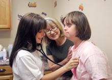 Abby Matthews of Summit listens to Debra Ann Breazeale's heartbeat on June 5, 2012, as Starkville pediatrician Dr. Deborah Shirley oversees. Matthews is participating in the five-week Rural Medical Scholars program at Mississippi State University. (Photo by MSU Ag Communications/Kat Lawrence)