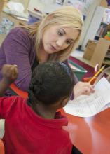 Michelle Cleveland, a senior from Tupelo in MSU's Human Development Family Studies program, completes a Get Ready to Read Screening Tool at the Brickfire Project as part of Starkville Rotary's community service project. (Photo by MSU Extension Service/Alicia Barnes)