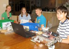 The Pearl River County senior 4-H Robotics team, from left Elsa Schmitz, Emily Bordelon, Bradley Guillot and Eric Bordelon, plans robot construction to prepare for an annual robotics contest. (Submitted Photo)