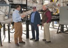 Rubin Shmulsky, left, head of sustainable bioproducts with the Mississippi State University Forest and Wildlife Research Center, explains on March 21, 2014, the process of converting wood chips into bio-oil during a visit with Leonard Gianessi, consultant to the CropLife Foundation in Washington, D.C. Bill Herndon, right, associate vice president for the MSU Division of Agriculture, Forestry and Veterinary Medicine, serves as Gianessi's host for a tour during a two-day visit to MSU. (Photo by MSU Ag Communi