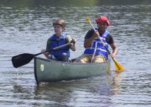 Young campers paddle across a lake during a Mississippi State University conservation camp in 2015. (Photo by MSU Extension Service/Kevin Hudson)