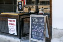 Signs with instructions for ordering curbside greet customers at a local coffee shop 