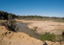 A river runs through a washed-out landscape.