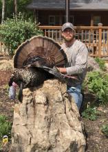 A hunter shows off a turkey he harvested.