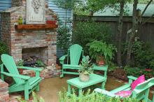 This outdoor fireplace with Adirondack-style chairs, matching coffee table, end table and loveseat creates a room that is soothing and inviting on our cooler days. (Photo by Norman Winter)