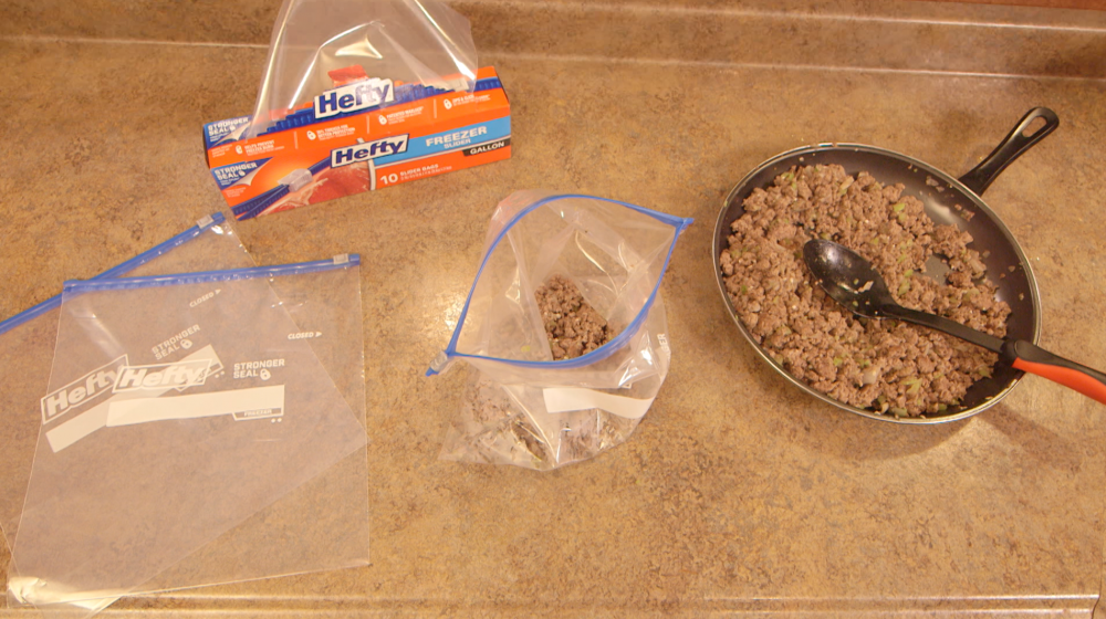 Browned ground beef, chopped onions, celery, and garlic in a non-stick skillet ready to spoon into individual freezer bags.