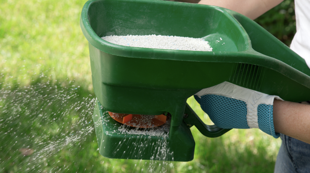 A person using a green manual fertilizer.