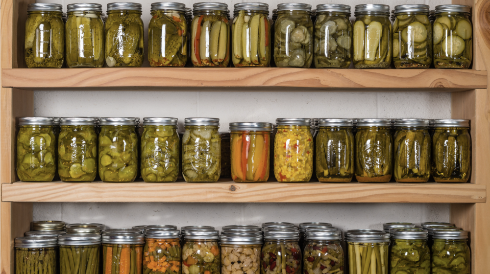 Canned fruits and vegetables on a shelf.