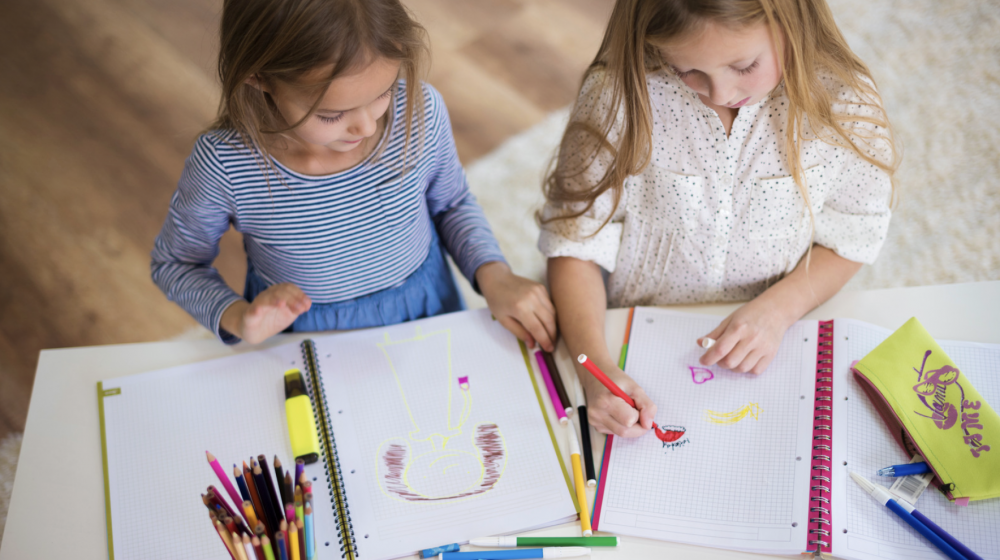 Two girls coloring. 