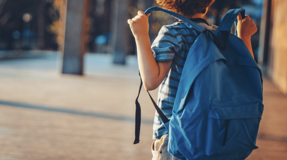 Boy with blue backpack.