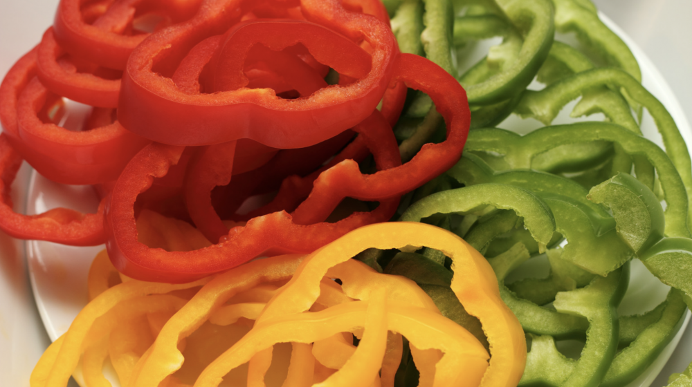 Sliced red, yellow and green bell peppers