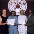 Virginia Whittington, president of the Mississippi 4-H Volunteers Association, (from left) presents a certificate for 60 years of service to Thelma Harris of Adams County and Dessie Burks of Madison County. The two volunteers were honored recently during the state 4-H Congress at Mississippi State University. Joining in the presentation is Harvey Gordon, 4-H volunteer development specialist with MSU's Extension Service.