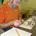 Dr. Jerome Goddard, a medical and veterinary entomologist with the Mississippi State University Extension Service, examines an insect specimen in his laboratory on campus. Goddard hopes to use his experience as a public health entomologist for teaching, research and outreach. (Photo by Marco Nicovich)