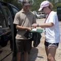 Vivian Cade with Mississippi State University Extension Service signs the paperwork to receive a bird to transport to the Wildlife Rehabilitation Center in Gulfport. (Photo MSU Extension/Alicia Barnes)