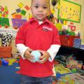 Two-year-old Anquarius Outlaw explores a variety of toys during free-choice center time at the Love & Learn Day Care in Crawford. (Photo by MSU Extension Service/Keri Lewis)