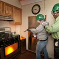 Donna Adams (left), area coordinator for Mississippi State University's student housing, and Calvin Mosley, associate director of student housing, extinguish a simulated fire in a trailer specifically designed for teaching fire control skills. Adams and Mosley are part of a group of 28 faculty and students who participated in MSU's Campus Community Emergency Response Team training. The CERT program educates people about disaster preparedness for hazards that may impact their area. The Nov. 8 training was ad