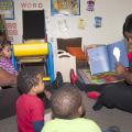 From left, Brenda Wright, owner of Heavenly Hearts Learning Center in Nesbit, joins Schmaya Miller, Kingston Jenkins and Ken'Narius Johnson to listen as LaLetrice Fletcher, field technical assistant with the Nurturing Homes Initiative, reads them a book. (Photo by MSU Extension Service/Alicia Barnes)